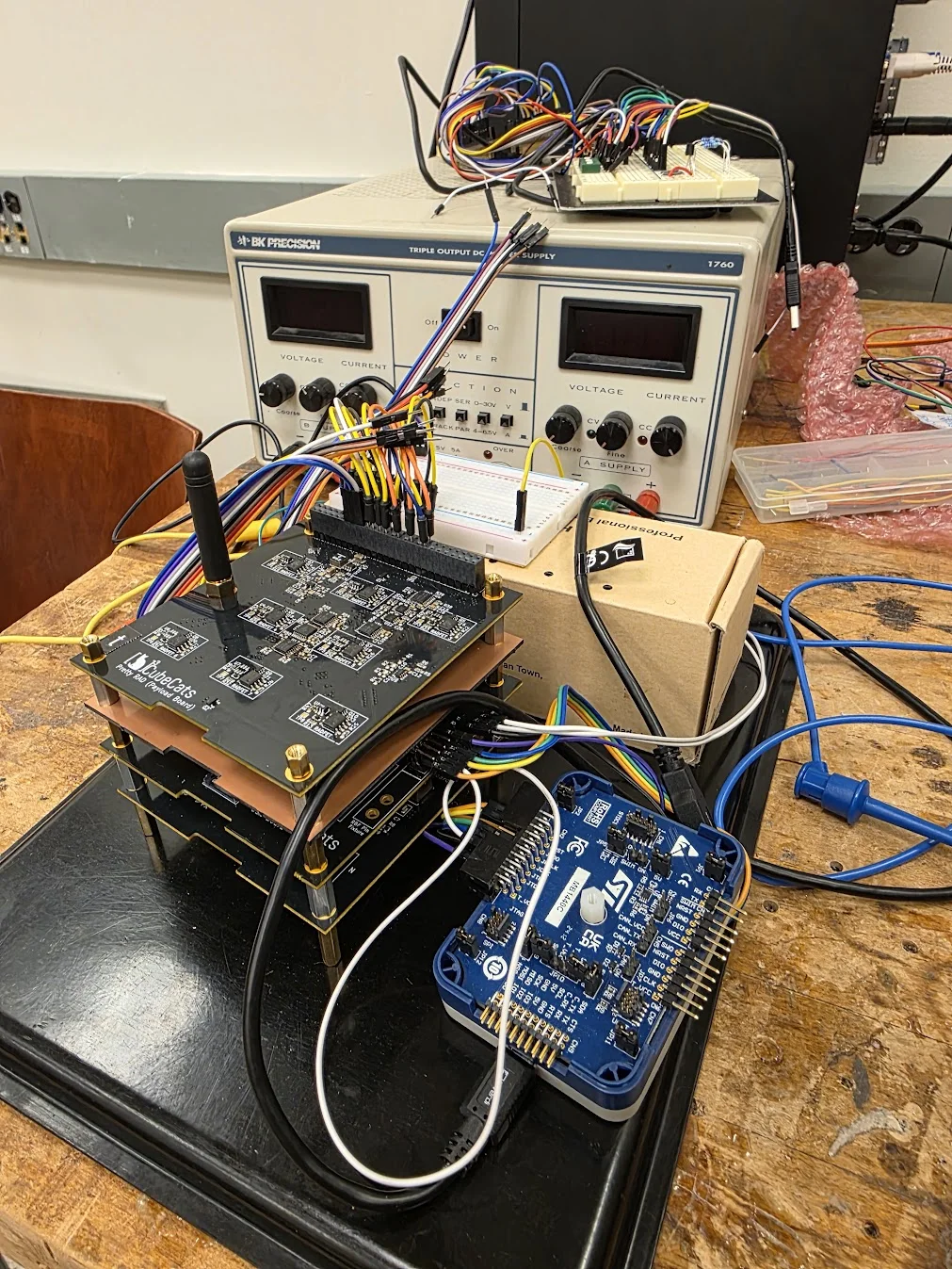 UC CubeCats satellite electronics connected to a test bench